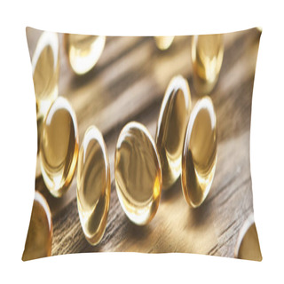 Personality  Close Up View Of Golden Fish Oil Capsules Scattered On Wooden Table, Panoramic Shot Pillow Covers