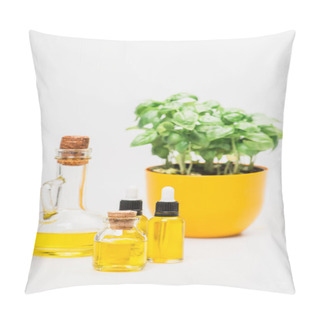 Personality  Selective Focus Of Green Plant In Flowerpot Near Essential Oil In Glass Bottles On White Background, Naturopathy Concept Pillow Covers