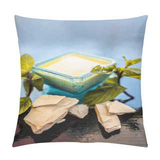 Personality  Fuller's Earth Or Mulpani Mitti Or Multani Mitti Or Bleaching Clay Well Mixed In A Blue Colored Glass Bowl Along With Some Mint Leaves For Decoration On It And Raw Clay Also On Wooden Surface. Pillow Covers