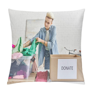 Personality  Promoting Social Good, Young Tattooed Woman Sorting Clothing In Plastic Container Near Carton Box With Donate Lettering In Modern Living Room, Sustainable Living And Social Responsibility Concept Pillow Covers