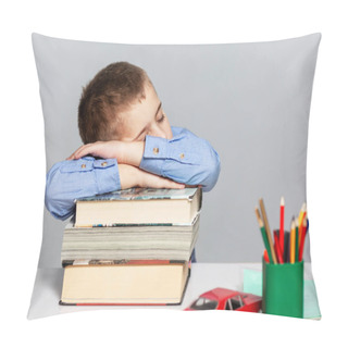 Personality  A Schoolboy Boy In A Blue Shirt Sleeps On A Stack Of Books At The Table. Learning Difficulties. Gray Background. Space For Text. Pillow Covers