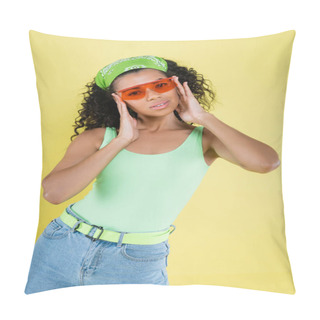 Personality  Young African American Young Woman In Green Kerchief Adjusting Orange Sunglasses Isolated On Yellow Pillow Covers