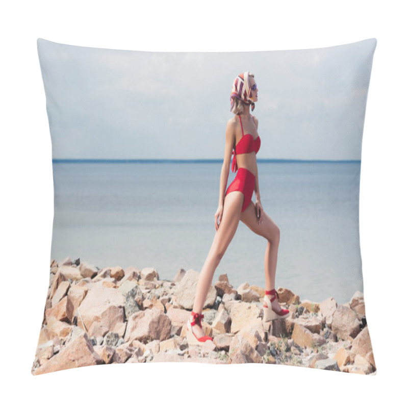 Personality  fashionable young woman posing in retro red bikini on rocky beach pillow covers