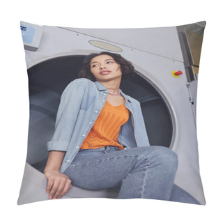 Personality  Low Angle View Of Young Asian Woman Looking Away While Sitting On Washing Machine In Public Laundry Pillow Covers