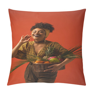 Personality  Positive Young African American Woman With Hand Near Face Holding Basket With Exotic Fruits On Red Pillow Covers