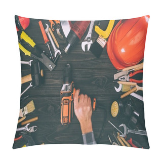 Personality  Cropped Shot Of Worker Holding Electric Screwdriver And Various Supplies On Wooden Tabletop Pillow Covers