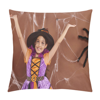 Personality  Joyous Little Witch In Halloween Costume And Pointed Hat With Raised Hands On Brown Backdrop Pillow Covers