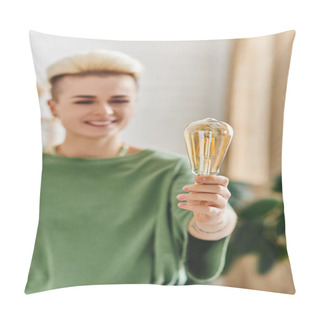 Personality  Cheerful Woman With Trendy Hairstyle, In Casual Clothes Smiling And Standing With Energy Saving Light Bulb At Home On Blurred Background, Sustainable Lifestyle And Environmentally Conscious Concept Pillow Covers