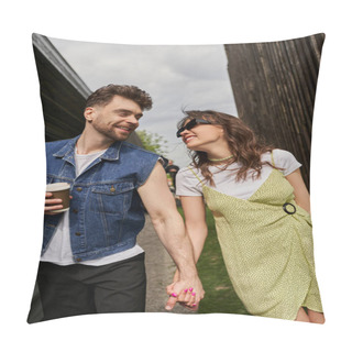 Personality  Cheerful Romantic Couple In Stylish Summer Outfits Holding Hands And Coffee To Go While Talking And Walking Between Wooden Houses In Rural Setting At Background, Outdoor Enjoyment Concept Pillow Covers