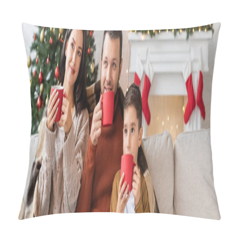 Personality  happy family drinking cocoa under warm blanket in living room with christmas decor, banner pillow covers