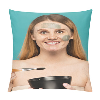 Personality  Happy Woman With Red Hair Holding Bowl And Cosmetic Brush While Applying Clay Mask Isolated On Turquoise  Pillow Covers