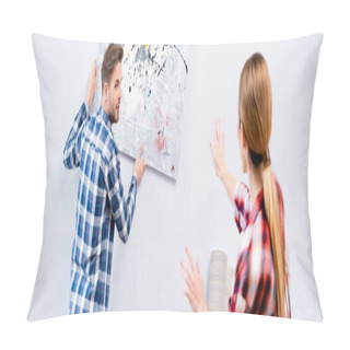 Personality  Young Man Looking At Woman Gesturing While Removing Picture From Wall On Blurred Foreground At Home, Banner Pillow Covers