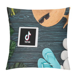 Personality  KYIV, UKRAINE - MARCH 25, 2020: Top View Of Digital Tablet With TikTok App Near Flips Flops, Straw Hat With Pebbles And Leaves On Dark Wooden Surface Pillow Covers