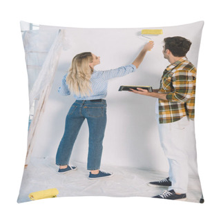 Personality  Young Woman Painting Wall In Yellow While Boyfriend Holding Roller Tray Pillow Covers