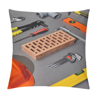 Personality  Flat Lay With Orange Helmet, Brick, Rivet Gun, Hammer, Screwdriver, Calipers, Spirit Level, Angle Keys And Pipe Connector On Grey Background Pillow Covers
