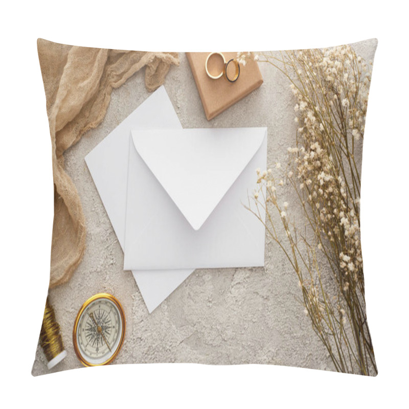 Personality  top view of envelope near beige sackcloth, golden compass and wedding rings on textured surface pillow covers