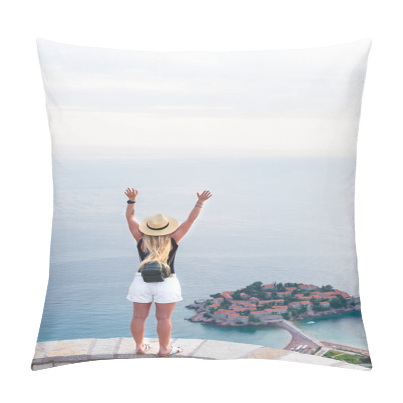 Personality  back view of woman standing with raised hands and looking at saint stephen island in Adriatic sea, Budva, Montenegro pillow covers