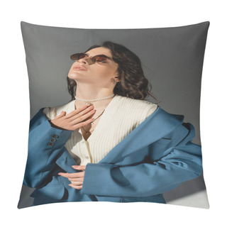 Personality  Sensual Woman In Pastel Blue Jacket And Stylish Sunglasses Posing With Hand On Chest On Grey Background Pillow Covers