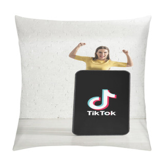 Personality  KYIV, UKRAINE - FEBRUARY 21, 2020: Cheerful Girl Showing Yeah Gesture While Standing Near Model Of Smartphone With TikTok App  Pillow Covers
