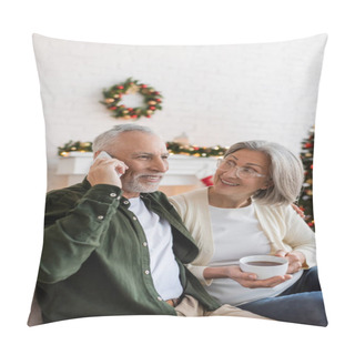 Personality  Happy Middle Aged Man Talking On Smartphone Near Wife With Cup Of Tea During Christmas  Pillow Covers