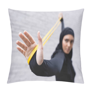 Personality  Selective Focus Of Arabian Sportswoman In Hijab Exercising With Resistance Band Near Brick Wall Pillow Covers