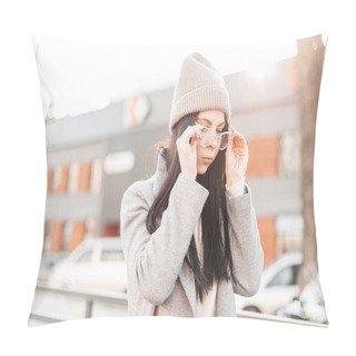 Personality  Young Stylish Beautiful Hipster Woman In Fashionable Knitted Hat In Vintage Coat Puts On Trendy Glasses In The City On The Background Bright Spring Sunset. Attractive Urban Girl Model Posing Outdoors. Pillow Covers