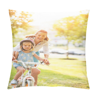 Personality  Portrait Of Happy Mother Helping Baby Girl Riding Bicycle In Par Pillow Covers