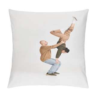 Personality  Couple In Casual Attire Performing An Intricate Acrobatic Balance In Studio On Grey Background Pillow Covers