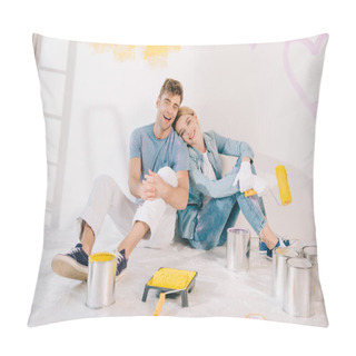Personality  Happy Young Woman Holding Yellow Paint Roller While Sitting On Floor Near Boyfriend Pillow Covers