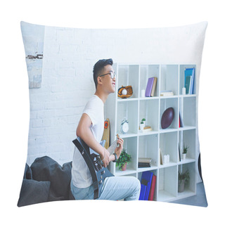 Personality  Side View Of Smiling Handsome Asian Man Playing Unplugged Electric Guitar At Home Pillow Covers