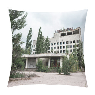Personality  PRIPYAT, UKRAINE - AUGUST 15, 2019: Building With Hotel Polissya Lettering Near Trees In Chernobyl  Pillow Covers