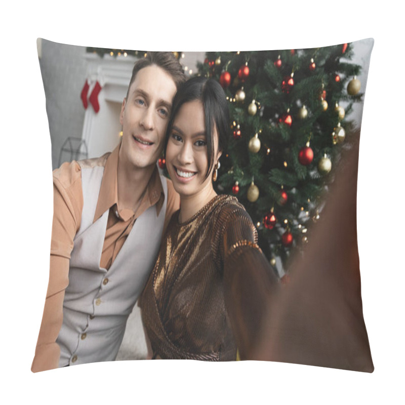 Personality  interracial couple smiling and looking at camera while sitting under Christmas tree  pillow covers