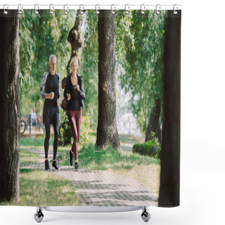Personality  Selective Focus Of Smiling Mature Sportsman And Sportswoman Running Together In Park Shower Curtains