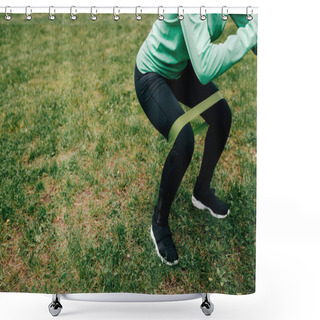 Personality  Cropped View Of Sportswoman Doing Squat With Resistance Band On Grass In Park  Shower Curtains