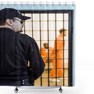 Personality  Rear View Of Prison Officer Standing Near Prison Cell With Multicultural Inmates Shower Curtains