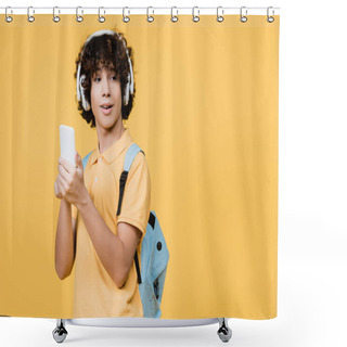 Personality  Curly Teenage Boy In Headphones Using Smartphone Isolated On Yellow Shower Curtains