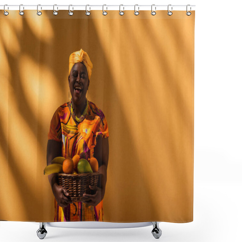 Personality  Smiling Middle Aged African American Woman In Bright Dress And Turban Holding Basket With Exotic Fruits On Orange Shower Curtains