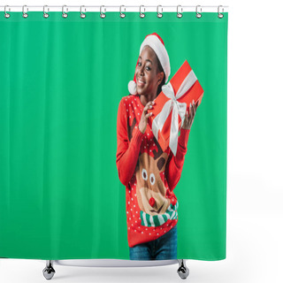 Personality  African American Woman In Christmas Sweater And Santa Hat Holding Gift Box And Looking At Camera Isolated On Green Shower Curtains