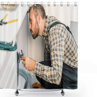 Personality  Side View Of Handsome Plumber Holding Adjustable Wrench And Looking Under Broken Sink In Kitchen Shower Curtains