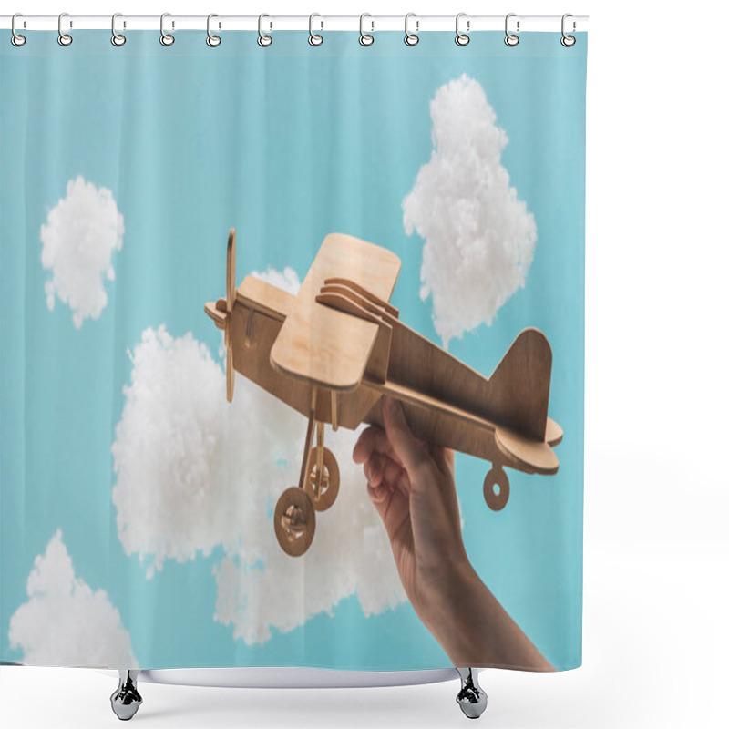 Personality  wooden toy plane flying among white fluffy clouds made of cotton wool isolated on blue shower curtains