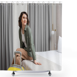 Personality  Young Woman With Brunette Hair, Wearing Casual Shirt And Pants, Sitting On Bed Near Yellow Suitcase, Looking Away And Smiling In Comfortable Hotel Room, Happy Traveler, Weekend Break Shower Curtains