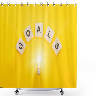 Personality  Top View Of Glowing Light Bulb Under 'goals' Word Made Of Wooden Blocks On Yellow Background, Goal Setting Concept Shower Curtains