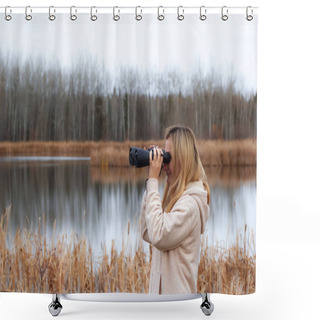Personality  A Blond Caucasian Woman In Beige Coat Is Watching Through Binoculars In The Park Near The Lake In Late Autumn. Shower Curtains