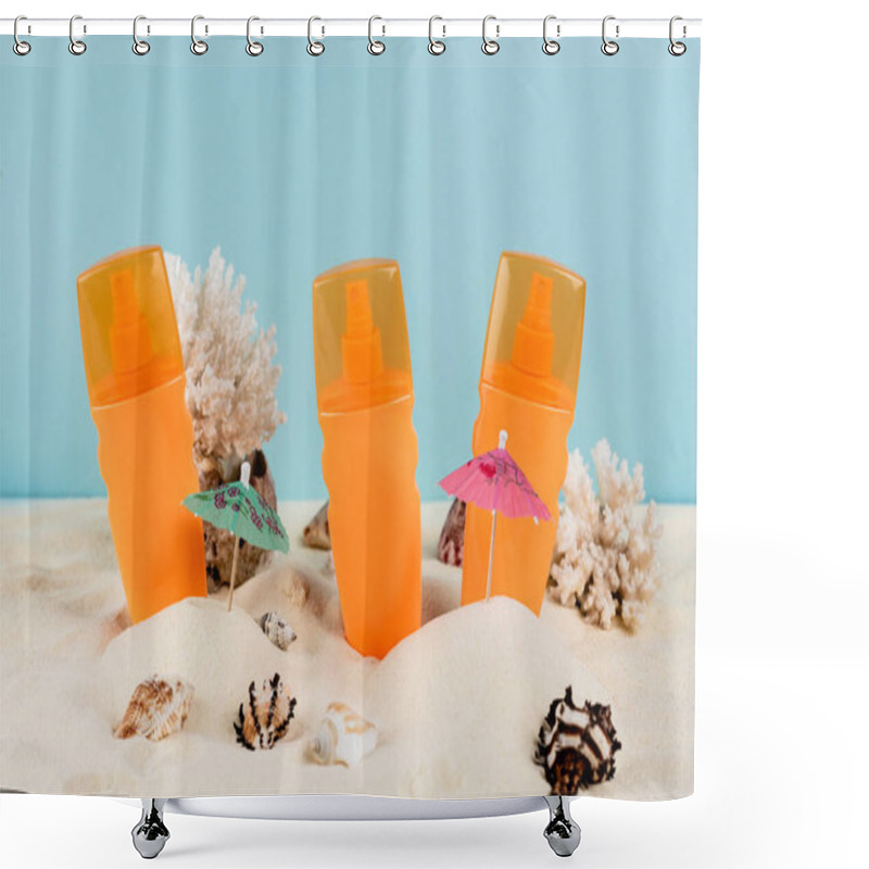 Personality  orange bottles of sunblock near seashells on sand isolated on blue shower curtains