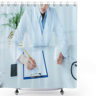 Personality  Cropped Shot Of Young Doctor Writing On Clipboard While Sitting At Workplace And Holding Pills Container Shower Curtains