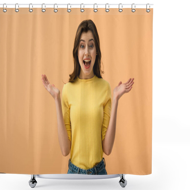 Personality  surprised brunette woman gesturing while standing  isolated on orange shower curtains