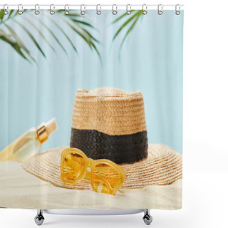 Personality  Selective Focus Of Yellow Sunglasses Near Straw Hat And Bottle With Suntan Oil On Sand Isolated On Blue Shower Curtains