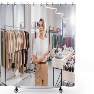Personality  Young Seller Using Digital Tablet While Standing In Showroom With Clothes  Shower Curtains