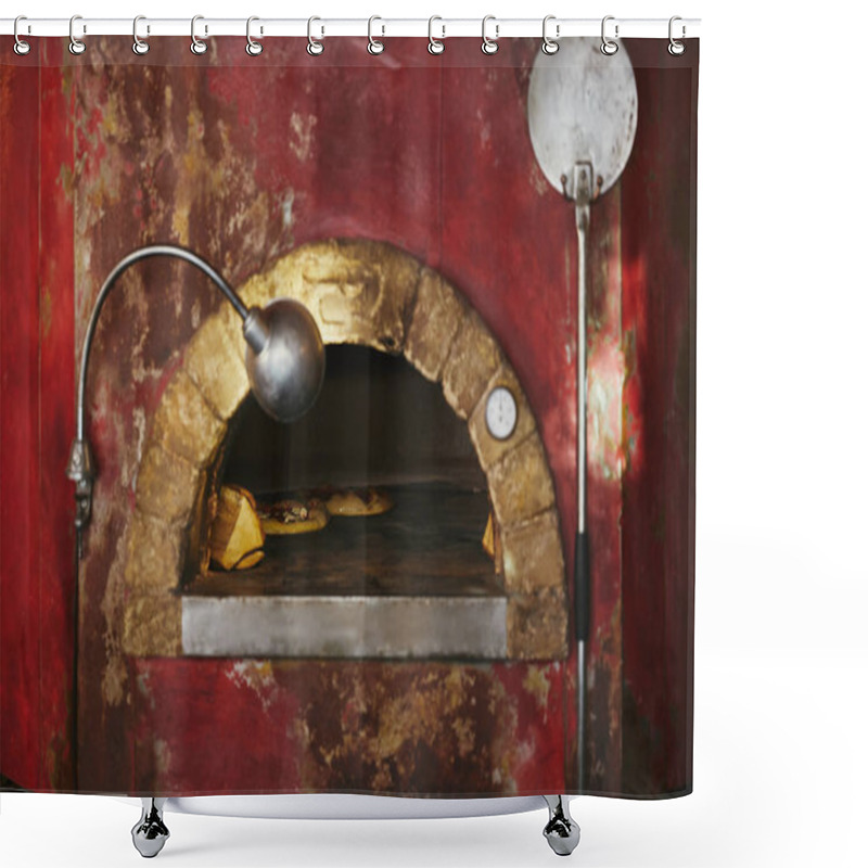 Personality  close-up shot of masonry oven at restaurant kitchen with baking pizza inside shower curtains