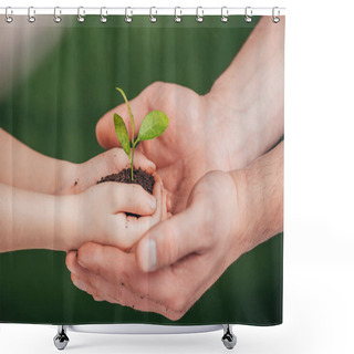 Personality  Cropped View Of Man Holding Child Hands With Young Plant On Blurred Background, Earth Day Concept Shower Curtains